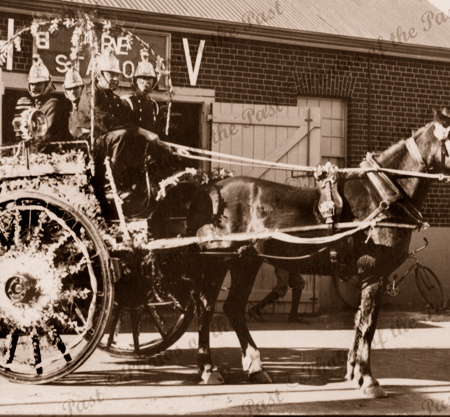 Old horse-drawn fire engine (decorated) with 4 firemen. Hindmarsh, SA. South Australia. 1900s