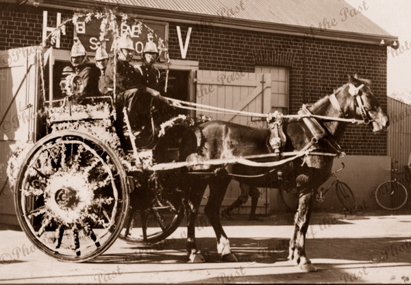 Old horse-drawn fire engine (decorated) with 4 firemen. Hindmarsh, SA. South Australia. 1900s
