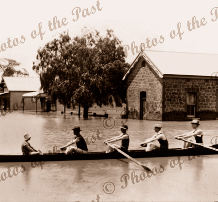 Rowers in flooded street, Mannum SA. South Australia. 1917. Murray River