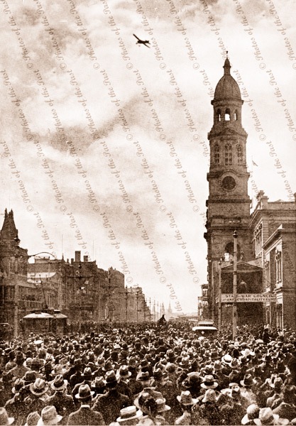 Harry Butler flying over Adelaide GPO, SA. December 1919. South Australia. Crowds