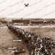 Harry Butler flying over Glenelg 28 December 1919. Horizontal format. South Australia. Jetty. Crowds.