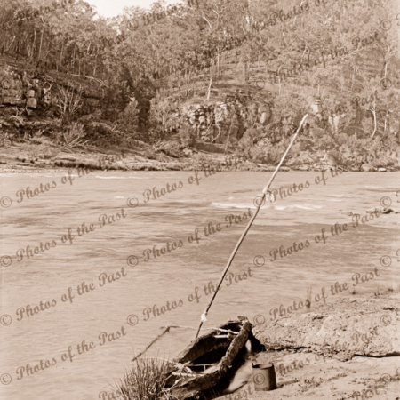 Aboriginal bark canoe, with out-rigger, on river bank, c1890