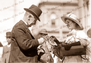 Wattle Day. Adelaide, SA. Posh gentleman buys a spray of wattle. 1918. South Australia.