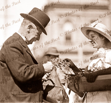 Wattle Day. Adelaide, SA. Posh gentleman buys a spray of wattle. 1918. South Australia.