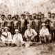 Group of Papuan men with visitors. Papua New Guinea
