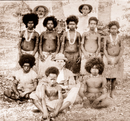 Group of Papuan girls & boys with three visitors. Papua New Guinea