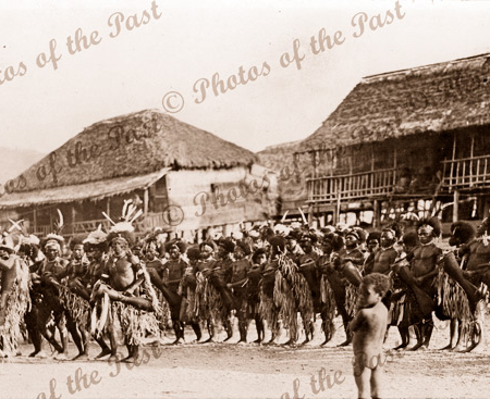European group at native village. Probably Hanuabada. Papua New Guinea. 1916