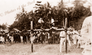 A pillow fight. Two boys fight it out at Samarai, Papua New Guinea. Red Cross Day. 1916