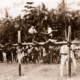 A pillow fight. Two boys fight it out at Samarai, Papua New Guinea. Red Cross Day. 1916