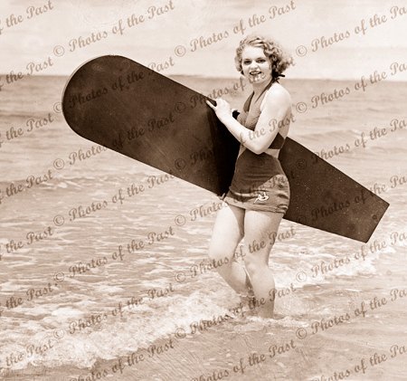 Girl with old time surf-board, 1940s