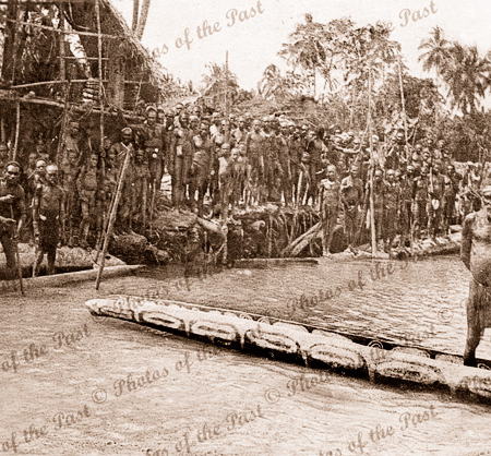 Native village. Houses on stilts. Dugout canoes. Papua New Guinea, c1920s