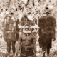 New Guinea natives in striking head-dresses. c1920s