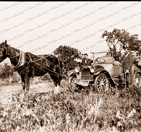Horse hauling a car in field. (One horse-power!). c1920s