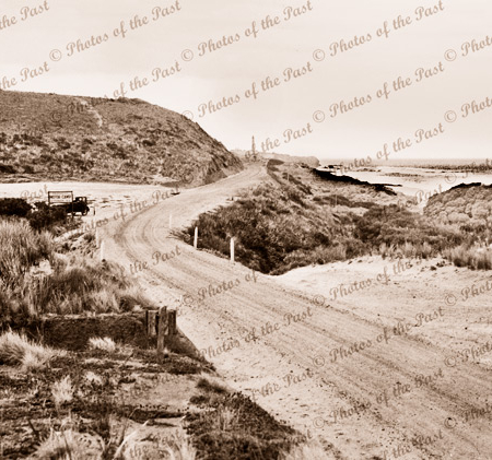 View across Moggs Creek bridge to Aireys Inlet. Sign for Fairhaven Motor Camp. Vic. c1930s