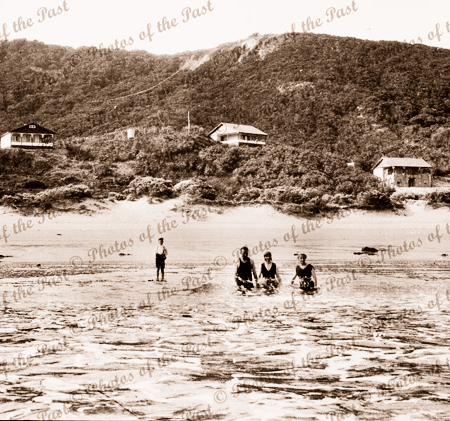 Bathers in sea at Eastern View. Great Ocean Road, Vic. Houses on hillside in background. c1920s-1930s