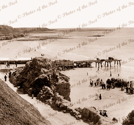 Port Willunga, S.A. Looking south across working jetty. People on beach. c1908